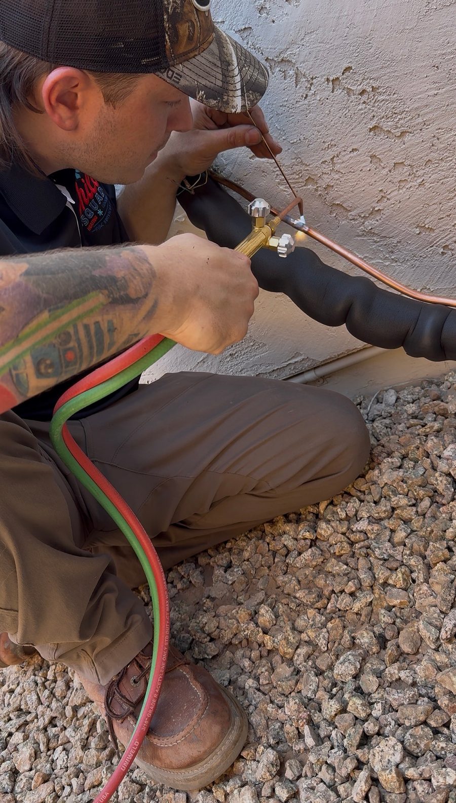 Steven of The Chill Squad HVAC brazing a copper refrigerant line set on a Phoenix air conditioning install